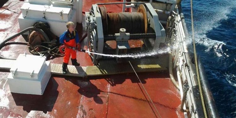 Læsø trawler havde danmarks yngste bedstemand med.  Foto: Johannes igang med at spule dæk - Andrea Klitbo